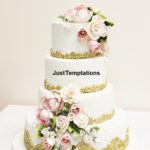 gold wedding cake with pink flowers