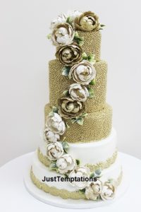 gold confetti and floral wedding cake