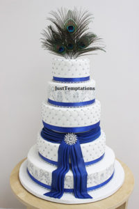 white and blue wedding cake with feathers