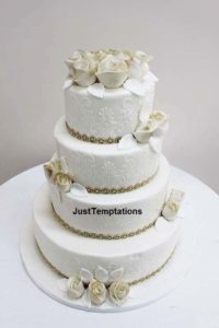 cream wedding cake with gold details