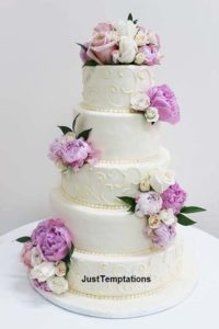 6 tiered cream wedding cake with purple flowers