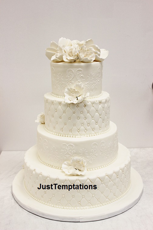 white wedding cake with few flowers