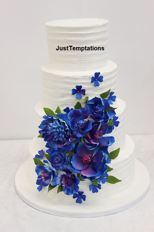 white wedding cake with blue flowers