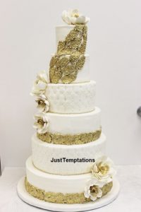 6 tiered white cke with gold decorations