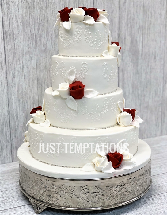 4 tiered white wedding cake with flowers