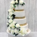 white flowers and gold wedding cake