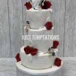 white and red flowers wedding cake