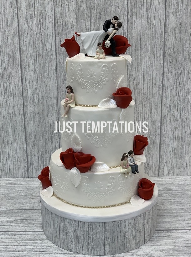 white and red flowers wedding cake